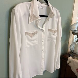 Vintage women’s button down blouse with embroidered detailing.